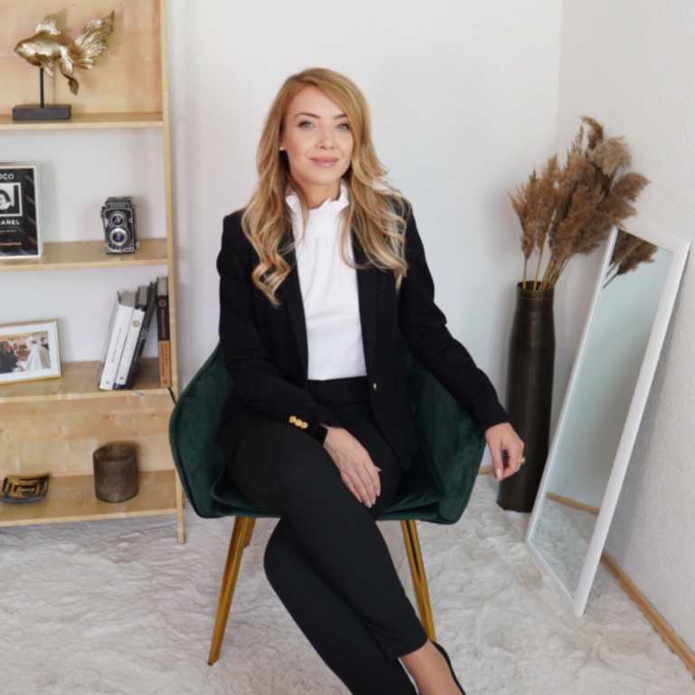 Confident elegant business woman sitting on a chair with open and confident body language smiling
