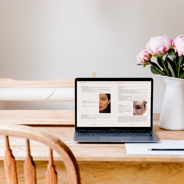 Laptop on a desk with flowers, minimalistic and elegant, on the screen is an opened ebook Elegant beauty by Kristina Szabova